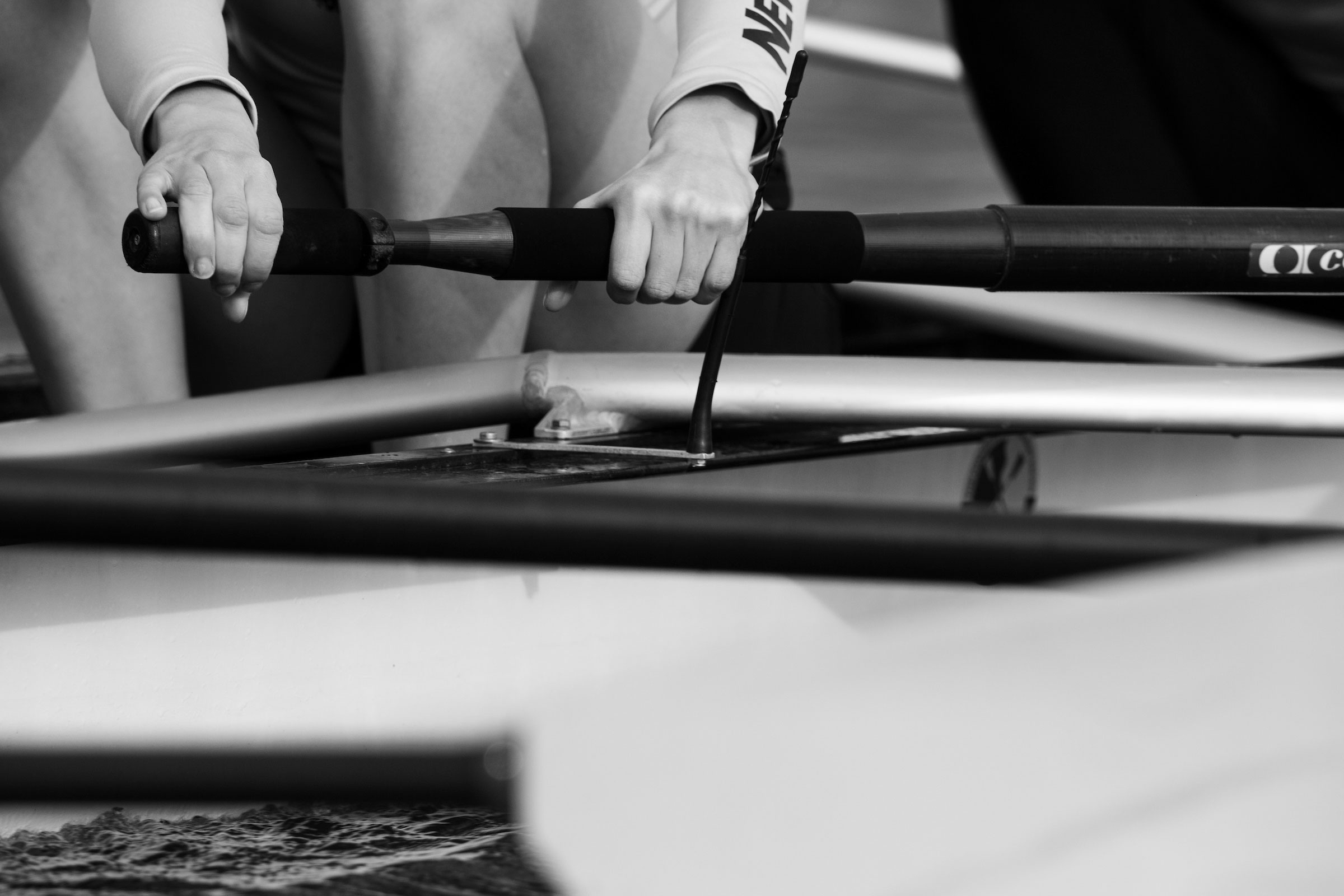 Rower gripping oar